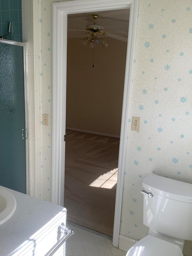 bathroom with walk in shower, ceiling fan, toilet, tile patterned floors, and vanity