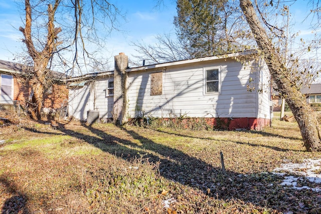 rear view of house with a yard