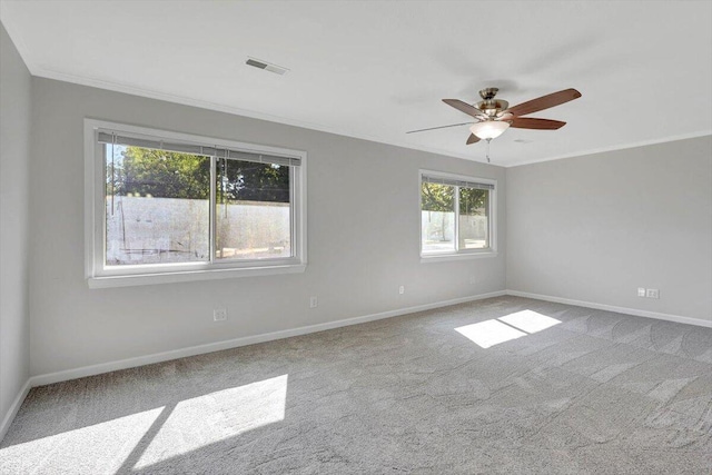 carpeted empty room with ornamental molding and ceiling fan