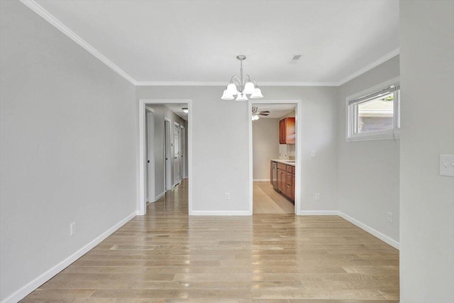 unfurnished dining area featuring ceiling fan with notable chandelier, ornamental molding, and light wood-type flooring