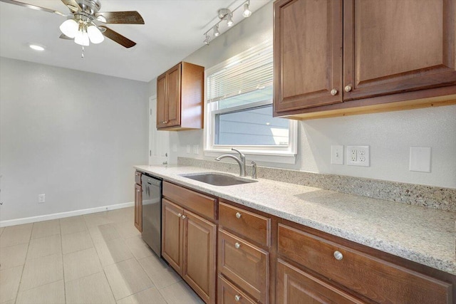 kitchen featuring ceiling fan, light tile patterned flooring, sink, dishwasher, and light stone countertops