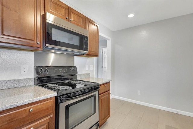 kitchen with light stone counters and stainless steel appliances