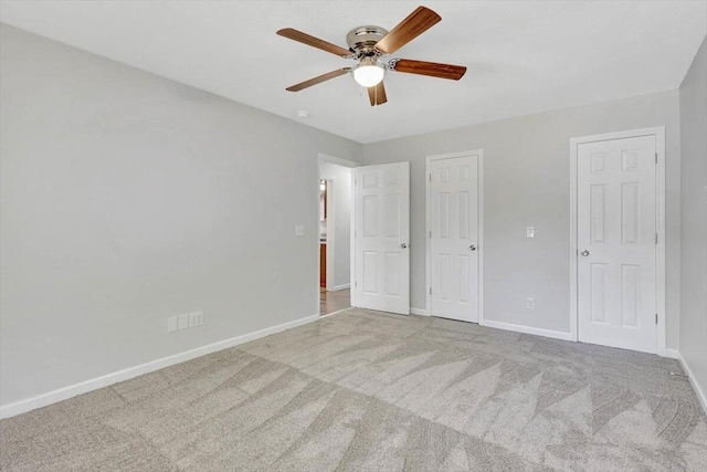 unfurnished bedroom featuring ceiling fan and carpet