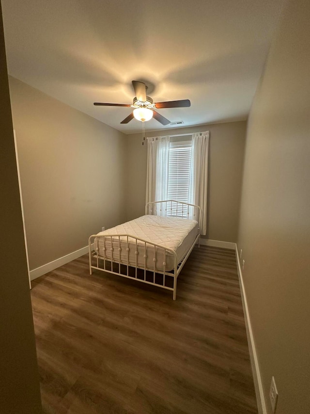 unfurnished bedroom featuring dark hardwood / wood-style flooring and ceiling fan