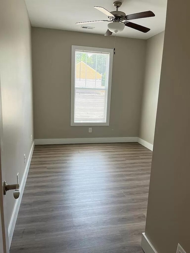 unfurnished room with ceiling fan and dark hardwood / wood-style floors