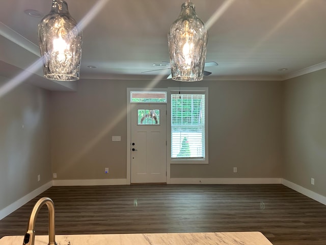 foyer with hardwood / wood-style flooring and crown molding