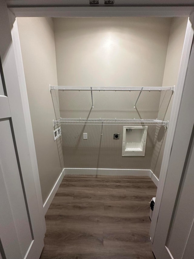 washroom featuring hookup for an electric dryer and dark hardwood / wood-style floors