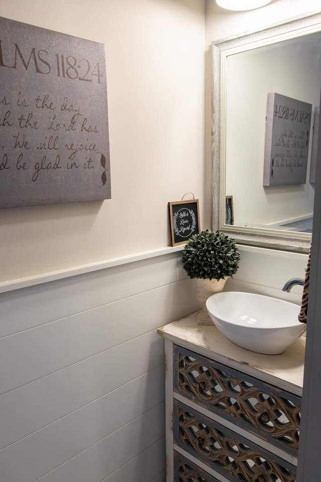 bathroom with vanity and tile walls