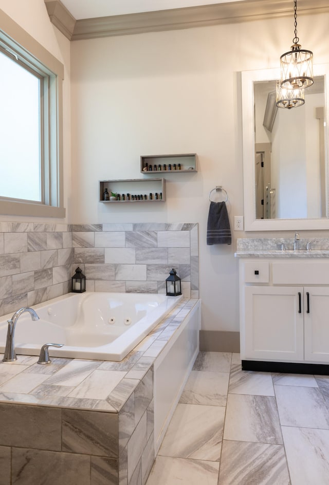 bathroom featuring vanity, an inviting chandelier, ornamental molding, and tiled bath