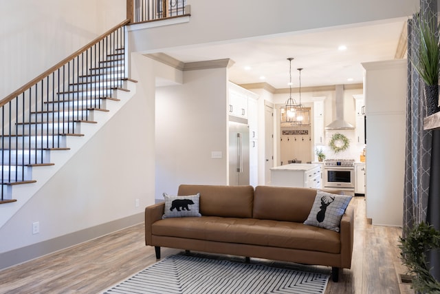 living room with light hardwood / wood-style floors and ornamental molding