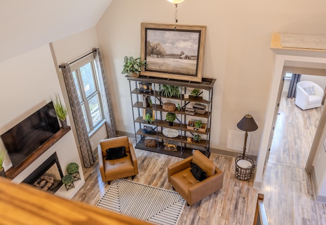 sitting room featuring vaulted ceiling and light hardwood / wood-style floors