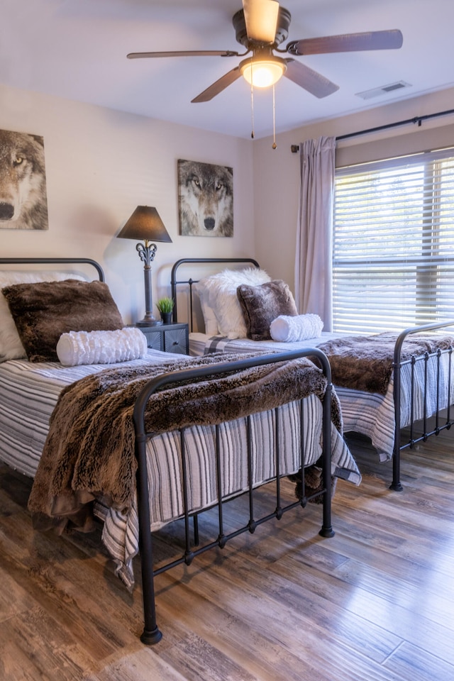 bedroom featuring ceiling fan and wood-type flooring