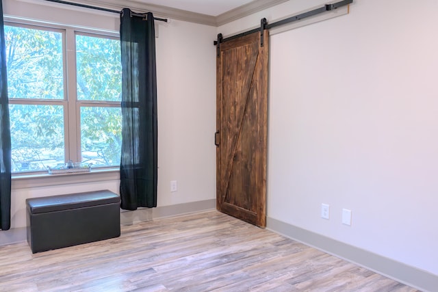 unfurnished room featuring light hardwood / wood-style floors and ornamental molding