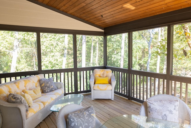 sunroom featuring vaulted ceiling, a healthy amount of sunlight, and wooden ceiling