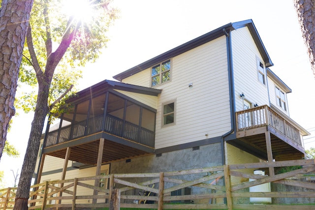 back of property with a sunroom