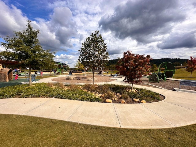 surrounding community with a playground and a lawn