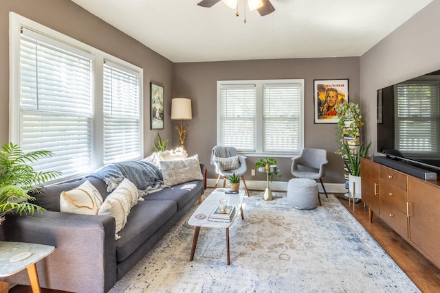 living room with ceiling fan and light hardwood / wood-style flooring