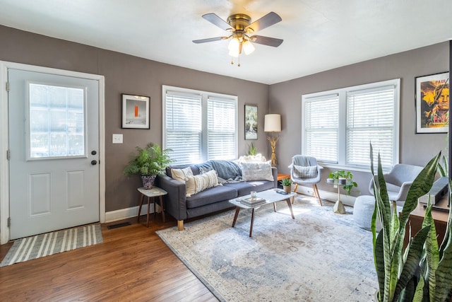 living room featuring a healthy amount of sunlight, ceiling fan, and hardwood / wood-style floors