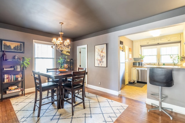 dining room featuring a notable chandelier and light hardwood / wood-style floors