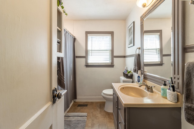 bathroom with vanity, tile patterned floors, toilet, and a shower with shower curtain