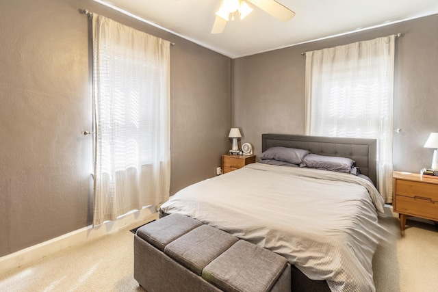 bedroom featuring multiple windows, carpet flooring, and ceiling fan