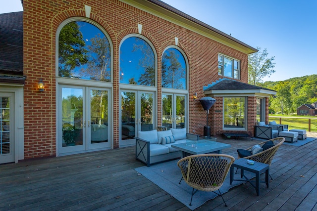 wooden terrace featuring outdoor lounge area