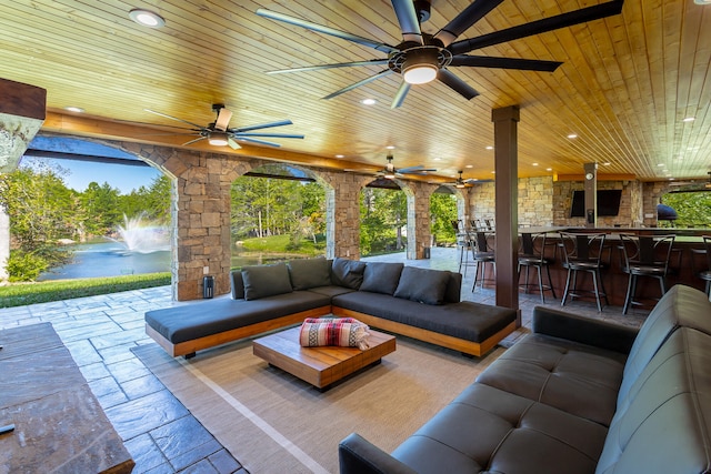 view of patio featuring an outdoor hangout area, exterior bar, and ceiling fan