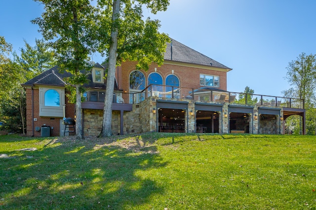 rear view of house featuring a lawn and cooling unit