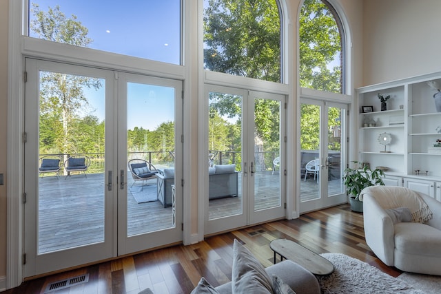 doorway to outside featuring french doors, a high ceiling, and dark hardwood / wood-style flooring