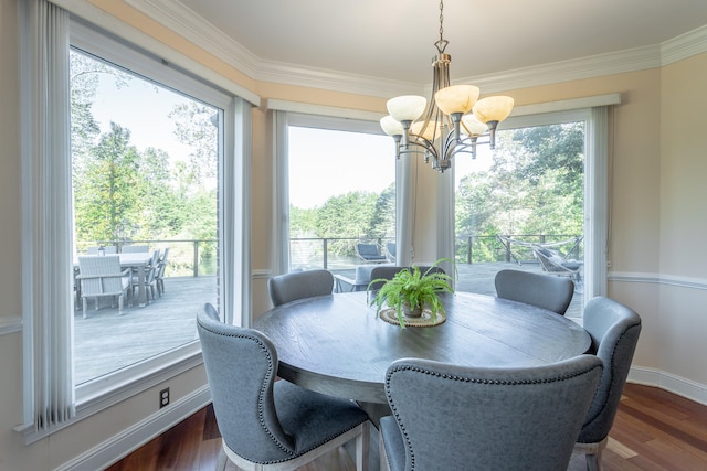 dining space featuring a notable chandelier, dark wood-type flooring, crown molding, and a wealth of natural light