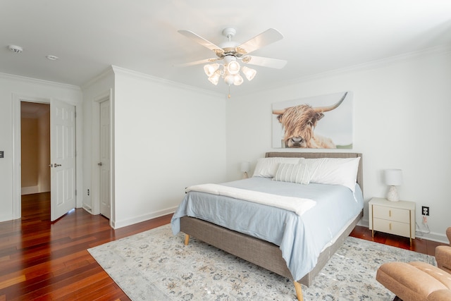 bedroom featuring ornamental molding, ceiling fan, and dark hardwood / wood-style flooring