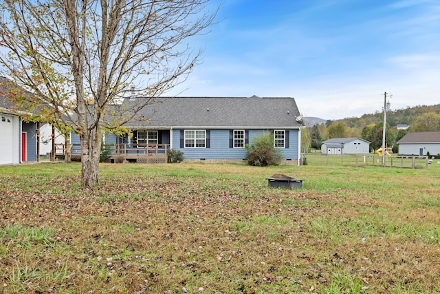 view of front of property with a front yard and a wooden deck