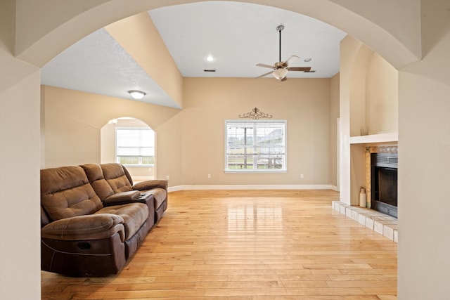 living room with light hardwood / wood-style floors and ceiling fan