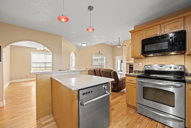 kitchen with stainless steel range with electric stovetop, a textured ceiling, a kitchen island, light wood-type flooring, and decorative light fixtures