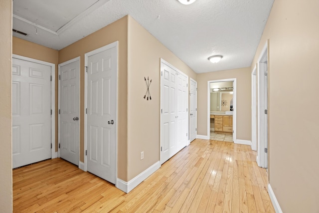 hall featuring hardwood / wood-style floors and a textured ceiling