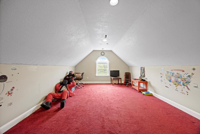 game room featuring carpet floors, a textured ceiling, and vaulted ceiling