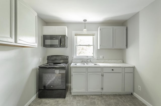 kitchen with white cabinets, black appliances, sink, and pendant lighting