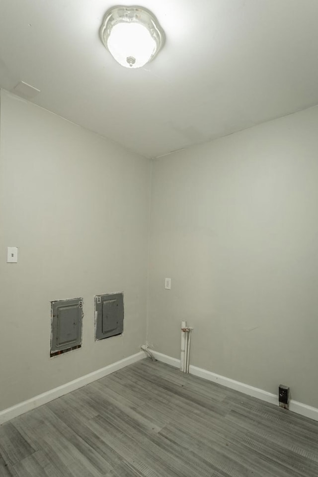 laundry area featuring hardwood / wood-style flooring and electric panel