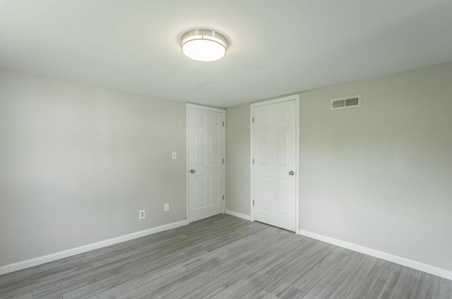 unfurnished room with light hardwood / wood-style floors