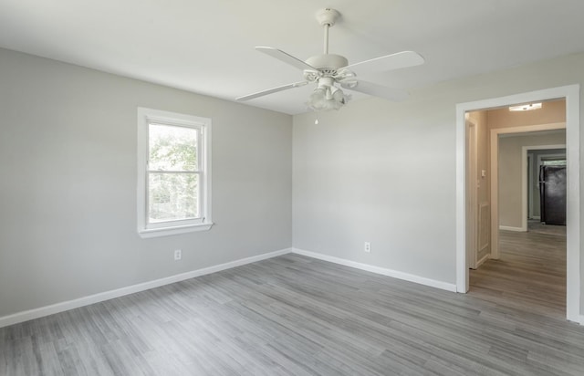 empty room with light hardwood / wood-style flooring and ceiling fan