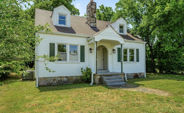 new england style home featuring a front lawn and central AC unit