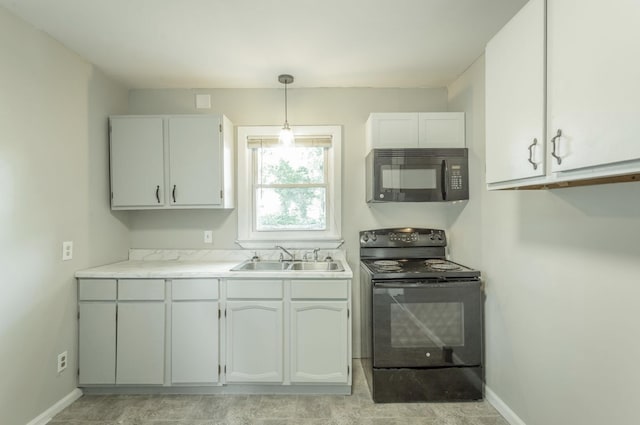 kitchen with sink, black appliances, white cabinetry, and pendant lighting