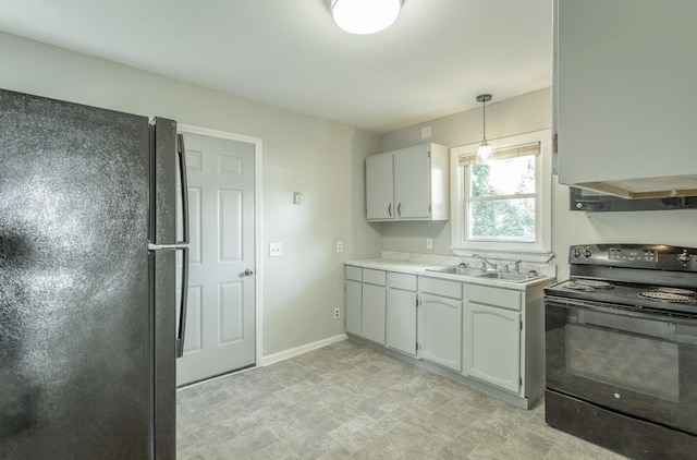 kitchen featuring white cabinetry, black appliances, sink, and pendant lighting