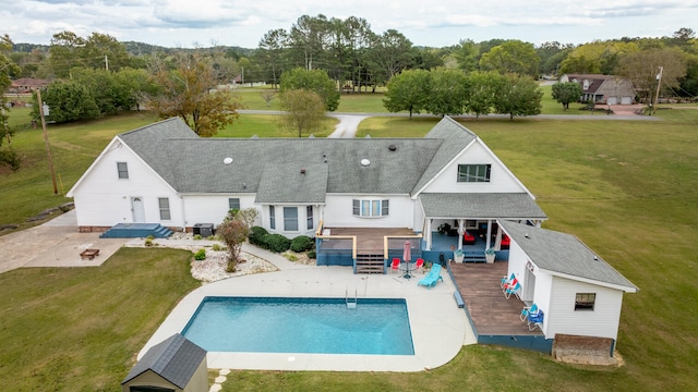 view of swimming pool with a patio area, a deck, and a lawn