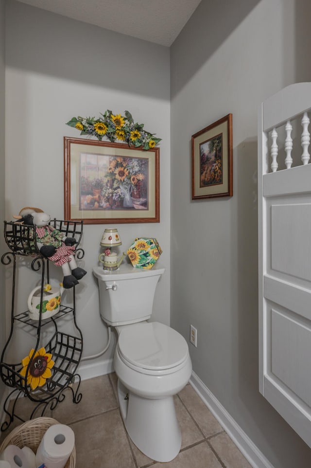 bathroom with toilet and tile patterned floors