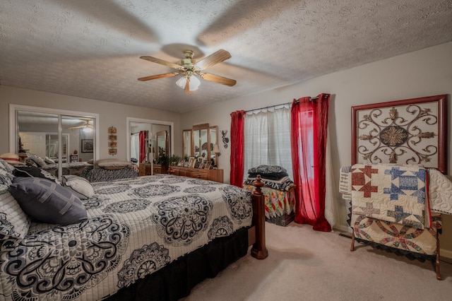 bedroom with a textured ceiling, carpet, and ceiling fan