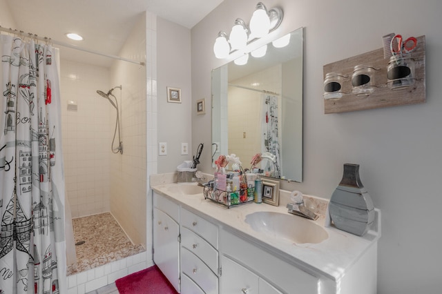 bathroom with vanity, curtained shower, and tile patterned flooring