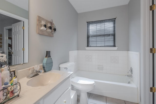 bathroom featuring vanity, toilet, a bathtub, and tile patterned flooring