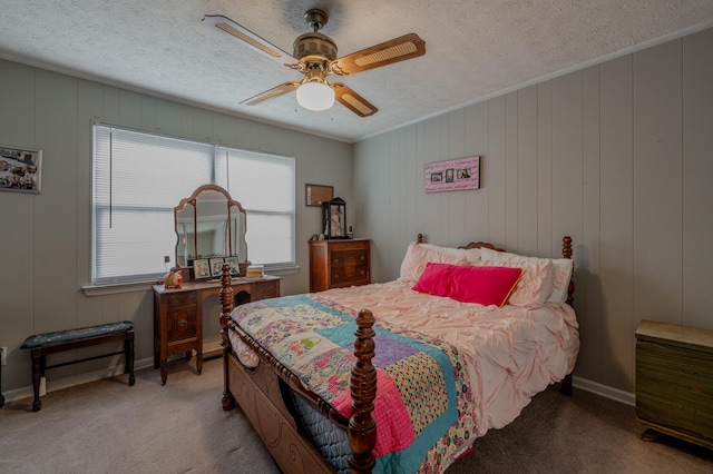 bedroom featuring ceiling fan, wood walls, ornamental molding, and carpet floors