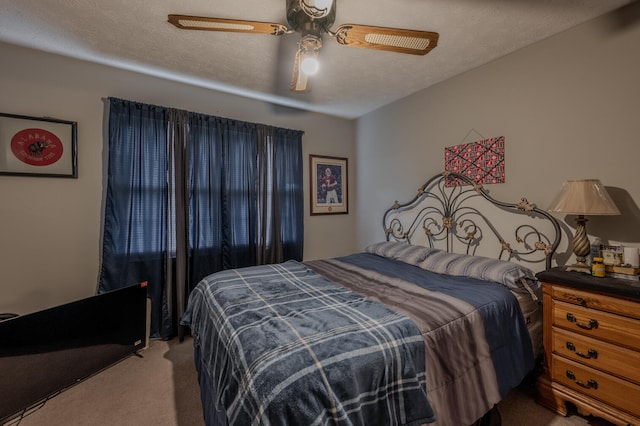 carpeted bedroom featuring a textured ceiling and ceiling fan